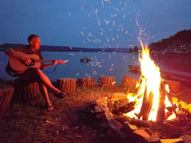 Chris strumming by the campfire
