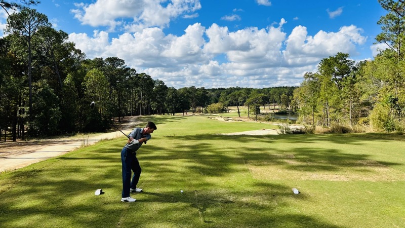 My playing partner teeing off