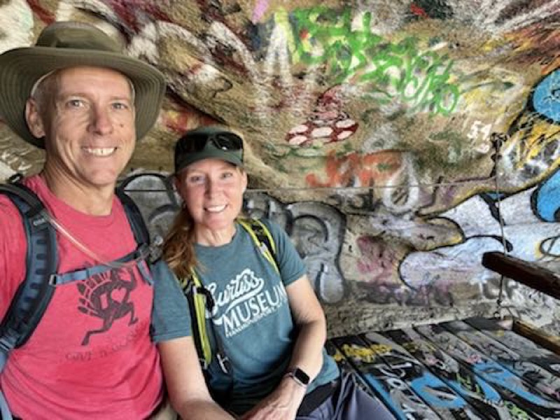 Chris and Julie sitting in a cave
