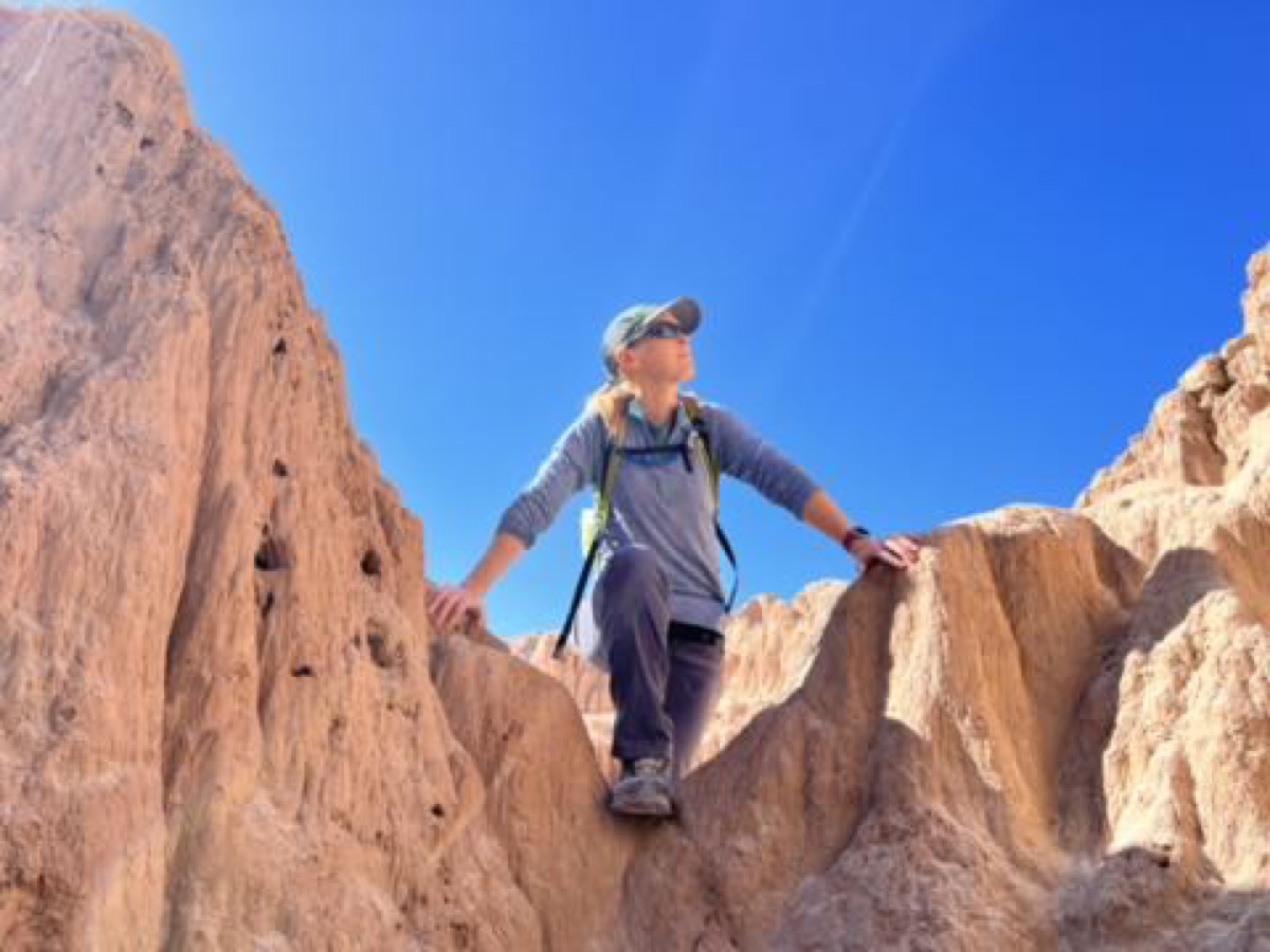 Julie scrambling over rocks