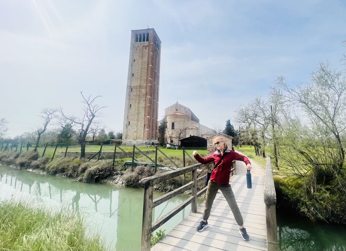 Julie on a Torcello bridge with tower in the background